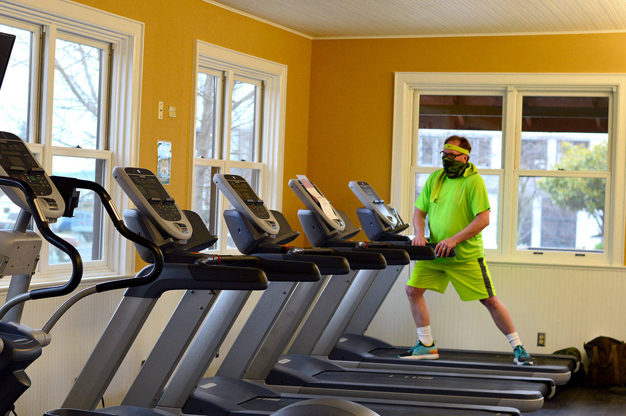 Richard Maxwell stretches before his Friday workout at the Port Townsend Athletic Club, which is about to double its capacity as North Olympic Peninsula gyms move into Phase 2 of the states economic recovery plan. (Diane Urbani de la Paz/Peninsula Daily News)