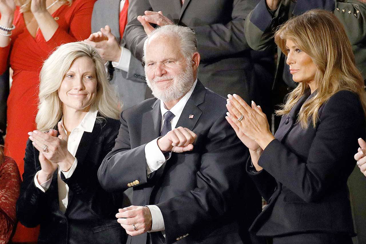 In this photo from Feb. 4, 2020, Rush Limbaugh reacts as first Lady Melania Trump, right, and his wife, Kathryn, applaud during President Donald Trump’s State of the Union address to a joint session of Congress on Capitol Hill in Washington. Limbaugh, the talk radio host who became the voice of American conservatism, has died. (Patrick Semansky/The Associated Press)