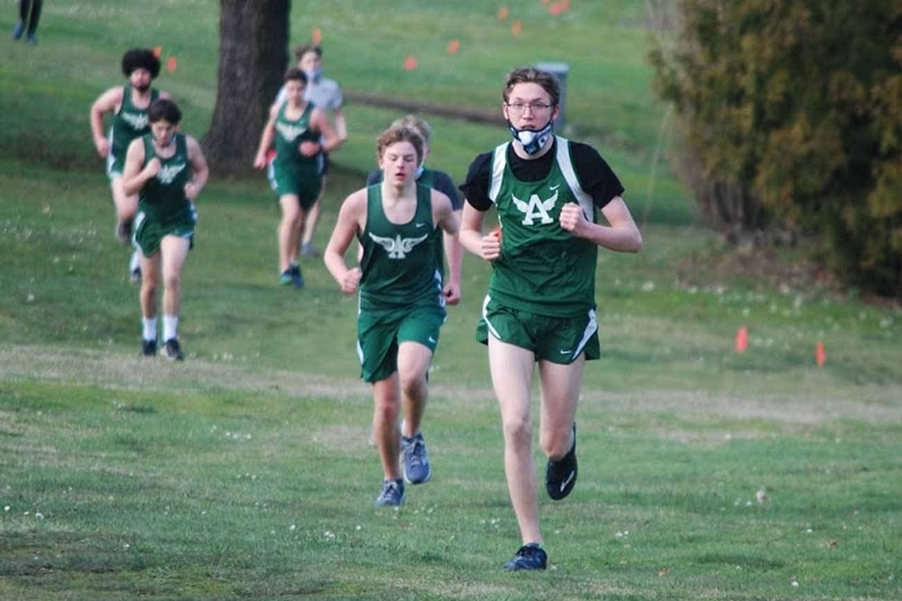 Port Angeles freshman Sam Hayes charges up a hill during a race at Port Townsend Golf Club on Wednesday. Hayes pushed hard and improved his 2-mile time by 15 seconds from the first race of the season. (Rodger Johnson/Port Angeles Cross Country)