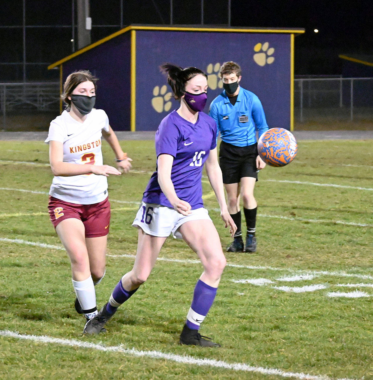 Michael Dashiell/Olympic Peninsula News Group Sequim midfielder Abby Schroeder, center, vies with Kingston Buccaneer Mandy Dormaier as they chase down a ball in the first half of Sequim’s 2-1 win over Kingston on Feb. 18.