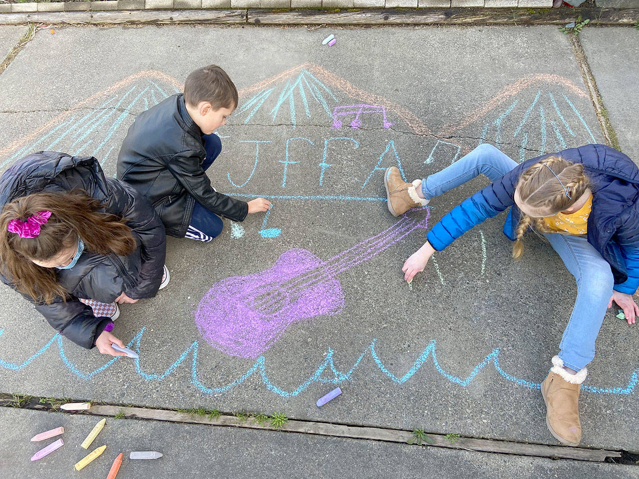 Warming up for Saturdays Chalk It Up! event are Cate Chance, 11, left, Lucas Chance, 7, and Sarah Butterworth, 10, all of Port Angeles. (Photo courtesy Juan de Fuca Foundation for the Arts)
