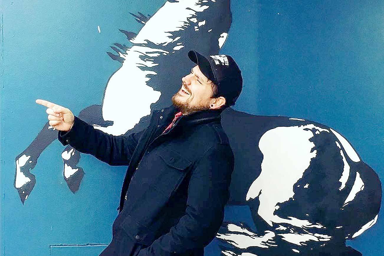 Singer Sam Chase, seen at a mural in Eugene, Ore., will give a free online performance Friday via the Juan de Fuca Foundation for the Arts' YouTube channel. (Photo courtesy The Sam Chase)
