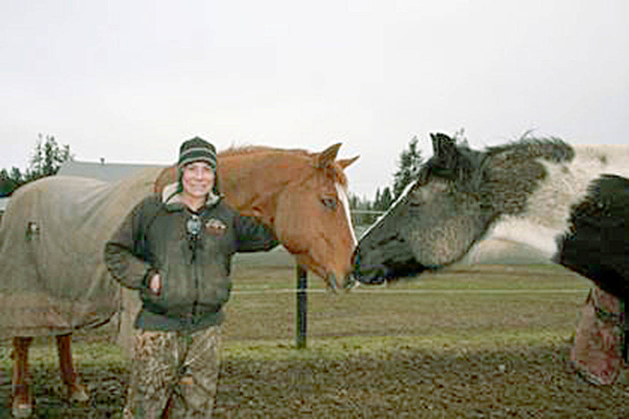 Kari Payne with two joys of her heart, Tree, left, and Stone who are now semi-retired from barrel races. She likes to give her animals one syllable, easy-to-remember names. (Karen Griffiths/for Peninsula Daily News)