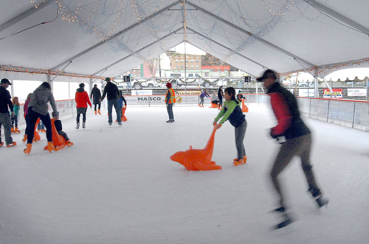 Skaters make their way around the rink in January 2020 at the Port Angeles Winter Ice Village. (Keith Thorpe/Peninsula Daily News)