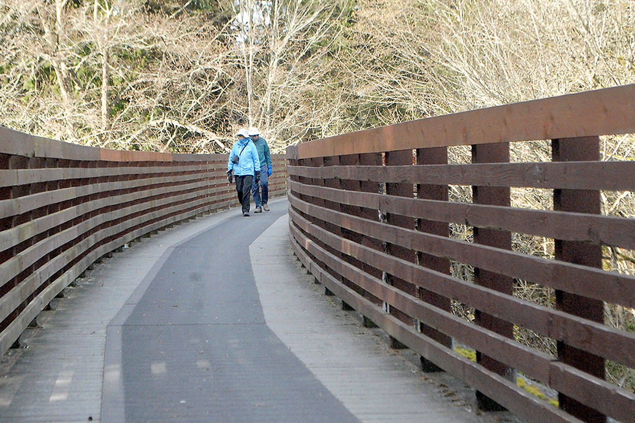 Joan and Bill Henry of Sequim stroll along the Johnson Creek Trestle, part of the Olympic Discovery Trail spanning Johnson Creek east of Sequim. The 410-foot-long trestle was refurbished in 2003 from a former railroad span and opened to pedestrian traffic. (Keith Thorpe/Peninsula Daily News)