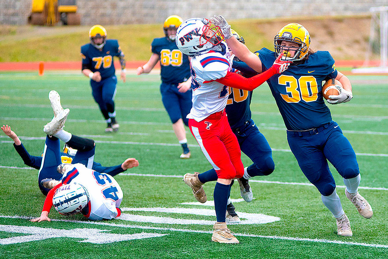 Forks' Hayden Baker (30) runs the ball against Pe Ell-Willapa Valley on Saturday. (Eric Trent/Daily Chronicle)