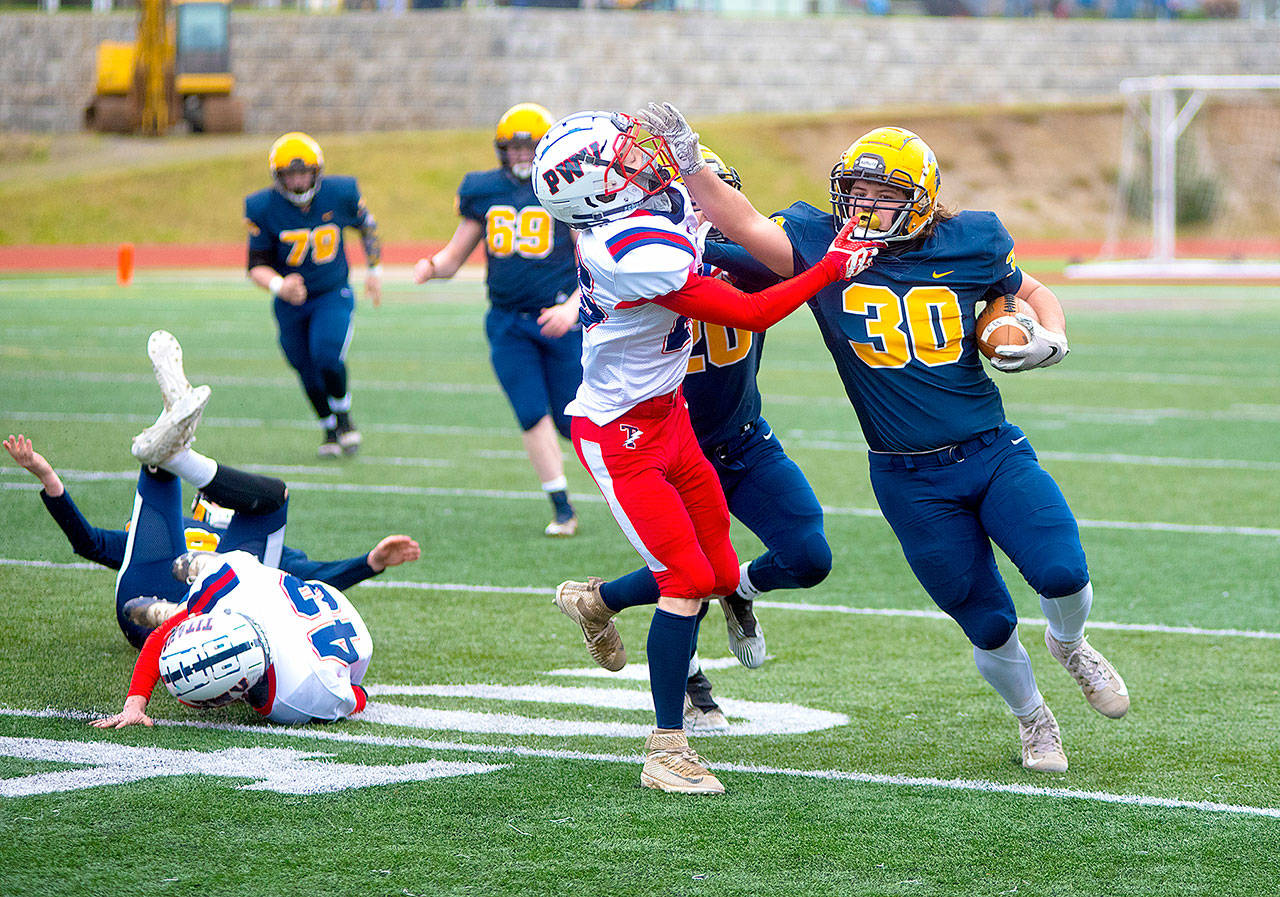 Forks Hayden Baker (30) runs the ball against Pe Ell-Willapa Valley on Saturday. (Eric Trent/Daily Chronicle)
