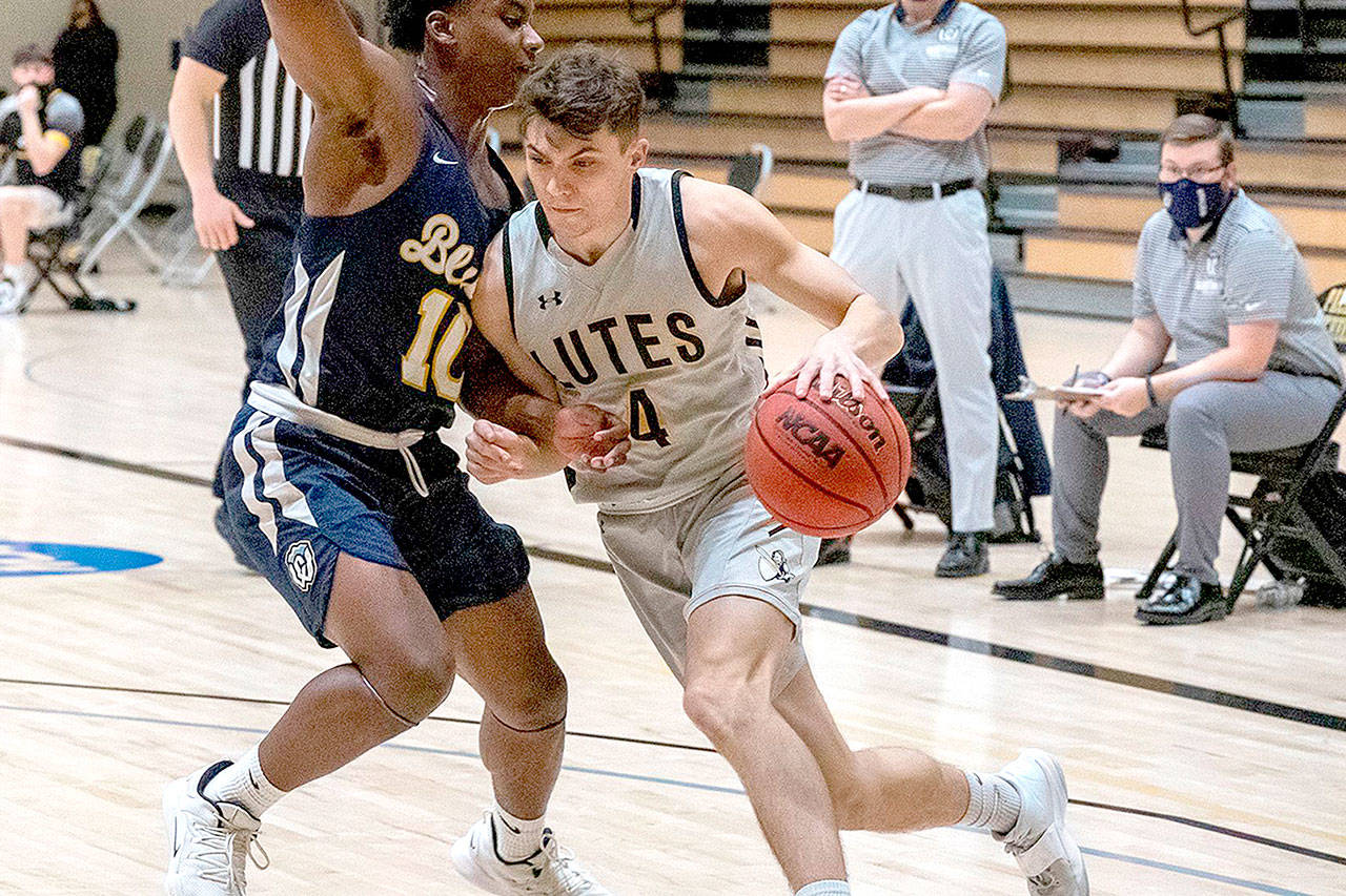Ally Downey/Pacific Lutheran University Athletics
Pacific Lutheran guard Grayson Peet drives during a game earlier this season. The 2017 Port Angeles grad sank two 3-point baskets in a win over rival Puget Sound on Saturday.