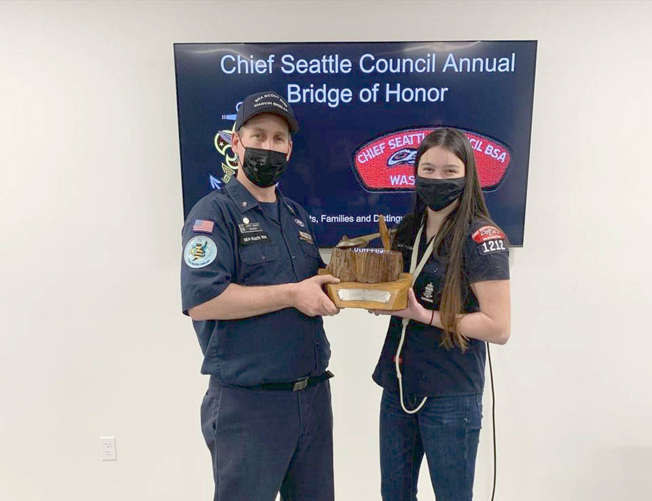 Skipper Jared Minard, left, and Ella Ventura, boatswain, accept the Hiltner Trophy for Sea Scout Ship Marvin Shields. The Chief Seattle Council named the Sea Scout Ship Marvin Shields, ship 1212, as its fleet flagship during a recent award ceremony. The selection as flagship allows the Marvin Shields to retain the traveling Hiltner Trophy and fly the flagship pennant at its masthead for the second year. The Sea Scouts is a program for youth ages 14-20. For more information, visit www.seascoutshipmarvinshields.org.