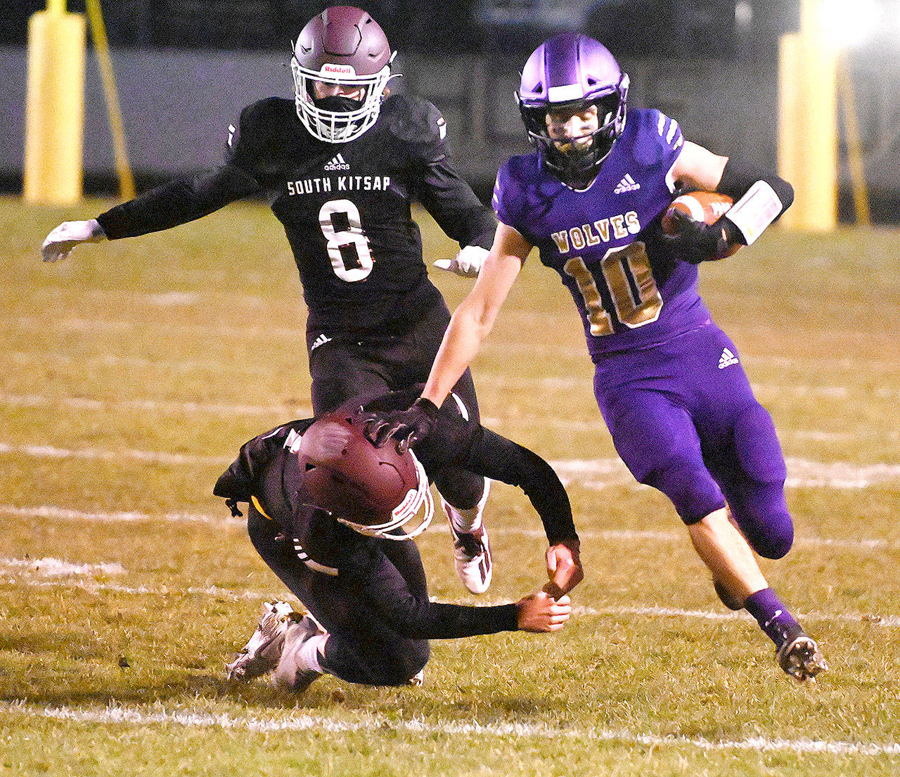 Sequim senior Garrett Hoesel, right, picks up 54 yards on a punt return in the first half of Sequim’s 27-15 home win over South Kitsap on Friday. Michael Dashiell/Olympic Peninsula News Group