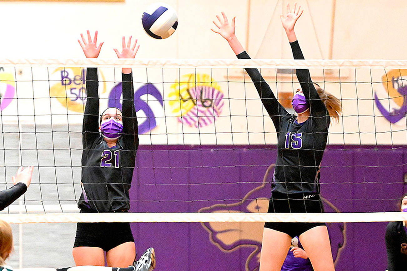Sequim’s Kalli Wiker (21) and Kendall Hastings look for a block as the Wolves take on — and beat — Klahowya on March 8 at home. Sequim Gazette photo by Michael Dashiell