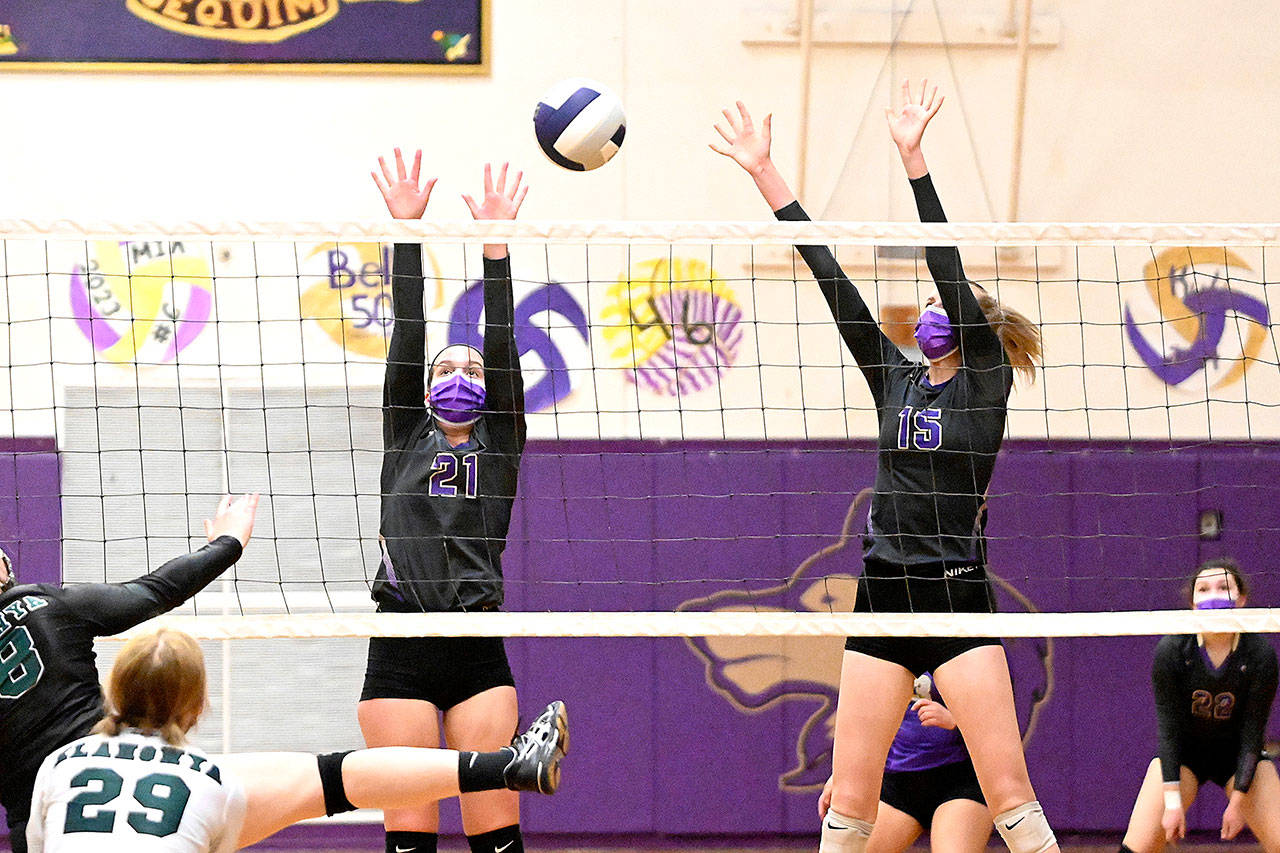Sequim’s Kalli Wiker (21) and Kendall Hastings look for a block as the Wolves take on — and beat — Klahowya on March 8 at home. (Michael Dashiell/Olympic Peninsula News Group)