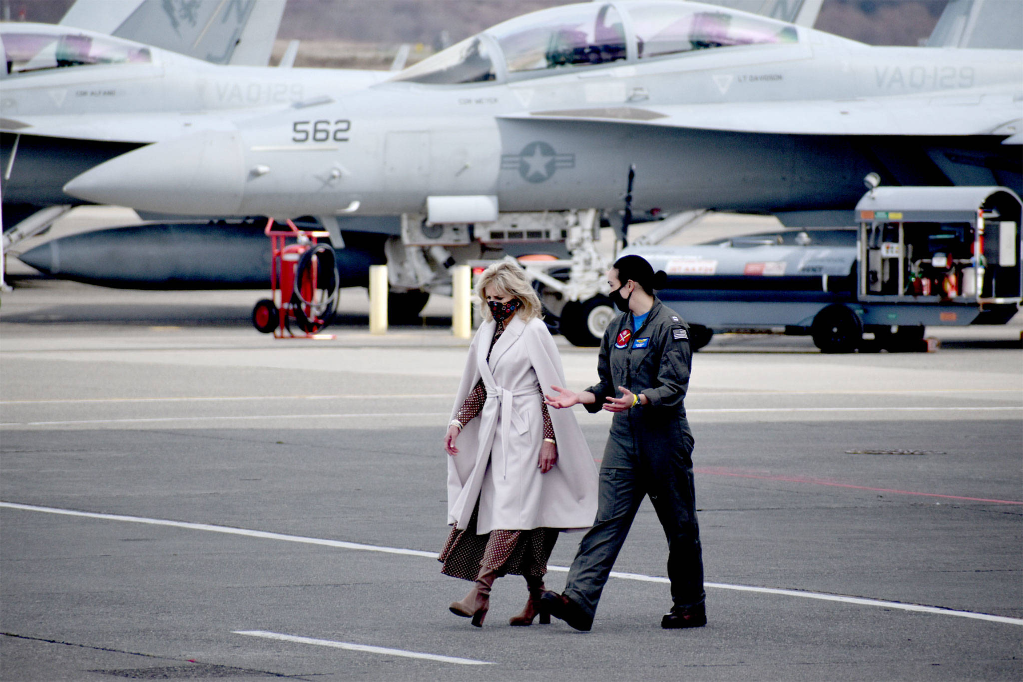 After a closeup look at an EA-18G, Dr. Jill Biden, left, talks with Lt. Cate Oakley, a Growler pilot at Naval Air Station Whidbey Island. The first lady visited the base Tuesday to meet with military families to listen to their concerns. (Photo by Emily Gilbert/Whidbey News-Times)