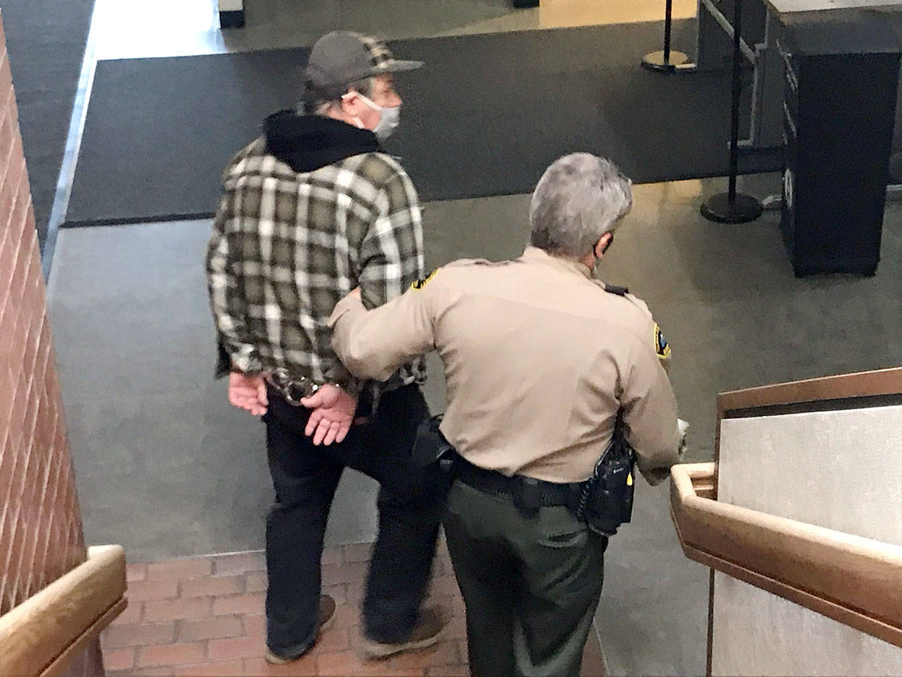 David Allen of Forks is led away to the Clallam County jail Wednesday to await sentencing after pleading guilty to two counts of child rape. (Paul Gottlieb/Peninsula Daily News)