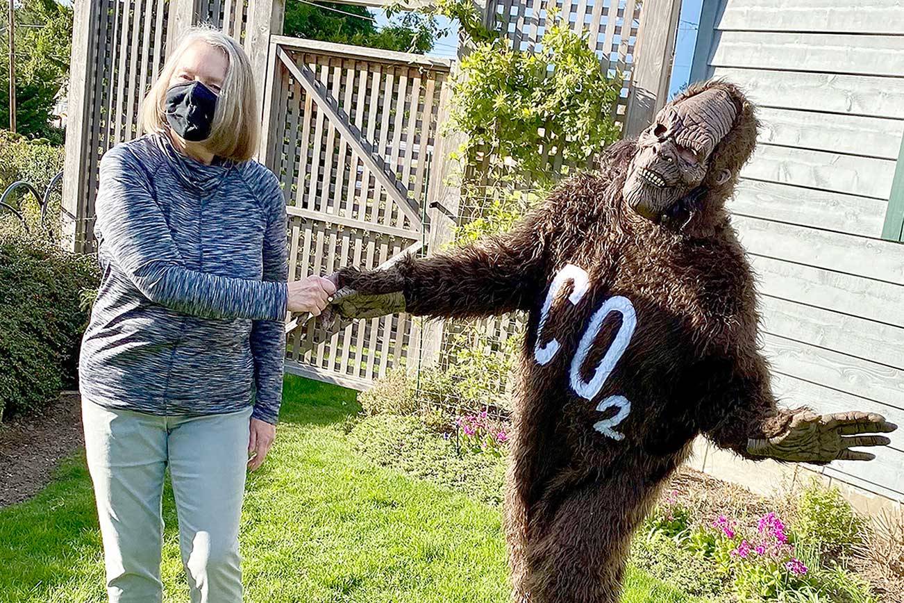 Carol Cummins of Port Townsend, winner of the Taming Bigfoot 2021 contest to reduce the carbon footprint in Jefferson County, receives congratulations from Bigfoot, otherwise known as Polly Lyle of Port Townsend. (Photo courtesy of Polly Lyle)