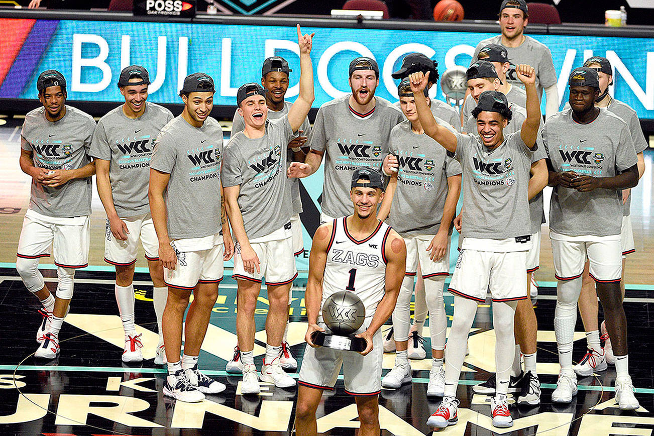 Gonzaga guard Jalen Suggs holds his tournament most outstanding player award after Gonzaga defeated BYU in an NCAA college basketball game in the West Coast Conference men's final, Tuesday, March 9, 2021, in Las Vegas. (AP Photo/David Becker)