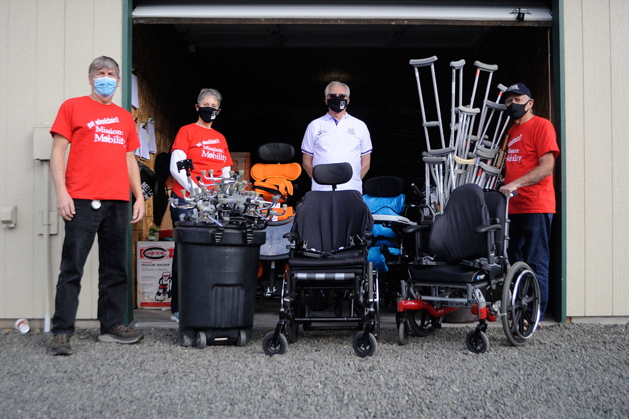 Volunteers at Dungeness Community Church, from left, Al Chrisman, organizer Rosalie DiMaggio, Martin Murray and Jim Coley seek donated wheelchairs, walkers and canes to ship to Guatemala to help people in Chimaltenango gain mobility. (Matthew Nash/Olympic Peninsula News Group)