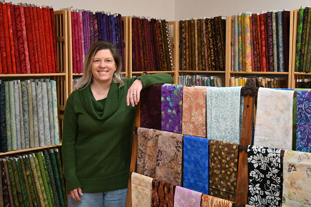 Nicole Driggs stands inside A Stitch in Time Quilt Shoppe, which opened last week on the 200 block of East Washington Street. Michael Dashiell/Olympic Peninsula News Group