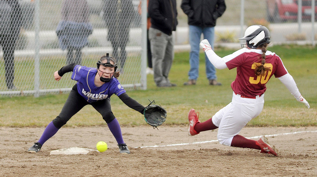 Sequim shortstop Hannah Bates looks to put a tag on a Kingston baserunner in the Wolves’ 19-3 win over the visiting Buccaneers on Wednesday. (Michael Dashiell/Olympic Peninsula News Group)