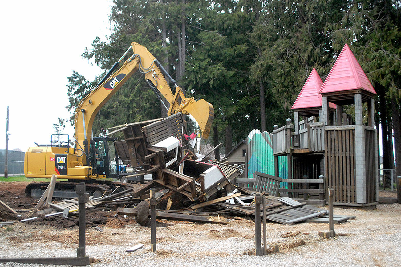 Keith Thorpe/Peninsula Daily News
An excavator operated by Greg Hopf of Port Angeles-based 2 Grade, LLC tears down a portion of the Dream Playground at Erickson Playfield in Port Angeles on Saturday to make way for a new play structure scheduled to be built this summer.