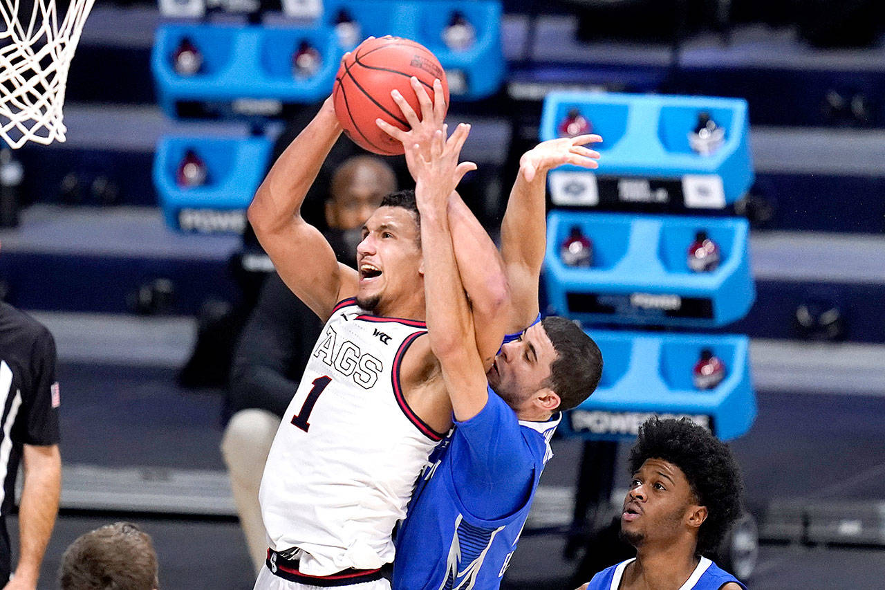 Gonzaga guard Jalen Suggs (1) drives on Creighton guard Marcus Zegarowski (11) in the second half of a Sweet 16 game in the NCAA men’s college basketball tournament at Hinkle Fieldhouse in Indianapolis, Sunday, March 28, 2021. (AP Photo/Michael Conroy)