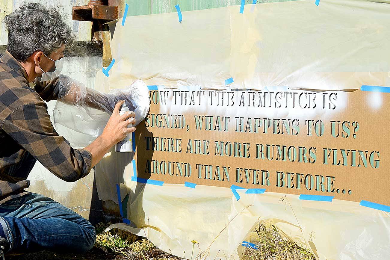 Aaron Asis, installing his “Fort Words” paintings at Fort Worden State Park last September, is among the many artists who have received Port Townsend Arts Commission grants. (Diane Urbani de la Paz/Peninsula Daily News)