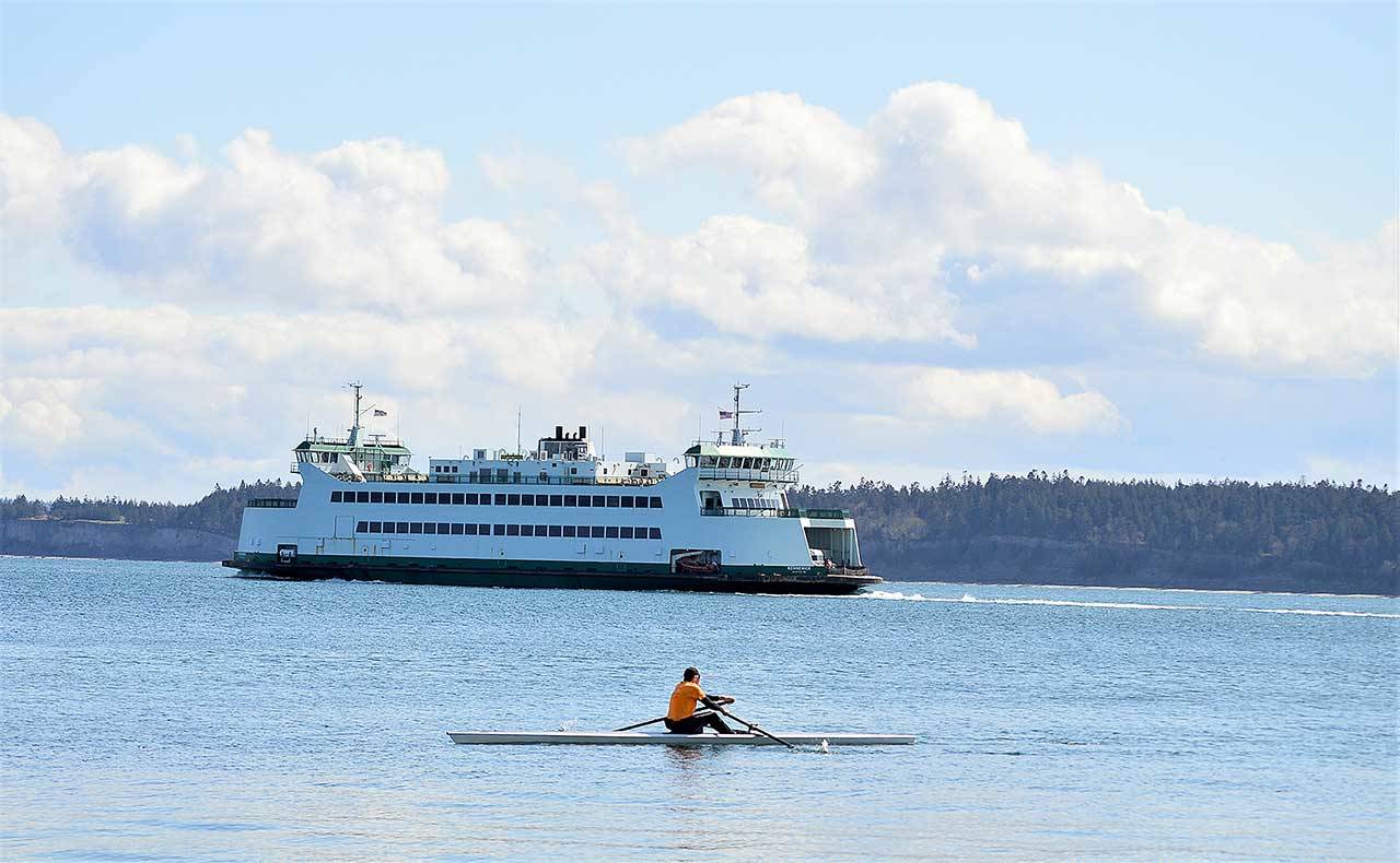 <strong>Diane Urbani de la Paz</strong>/Peninsula Daily News
Paul Carter of Port Townsend makes the most of the day’s sunshine as he joins a Washington State Ferry on Port Townsend Bay. Monday was his first time out on his single MAAS 24 rowing shell.