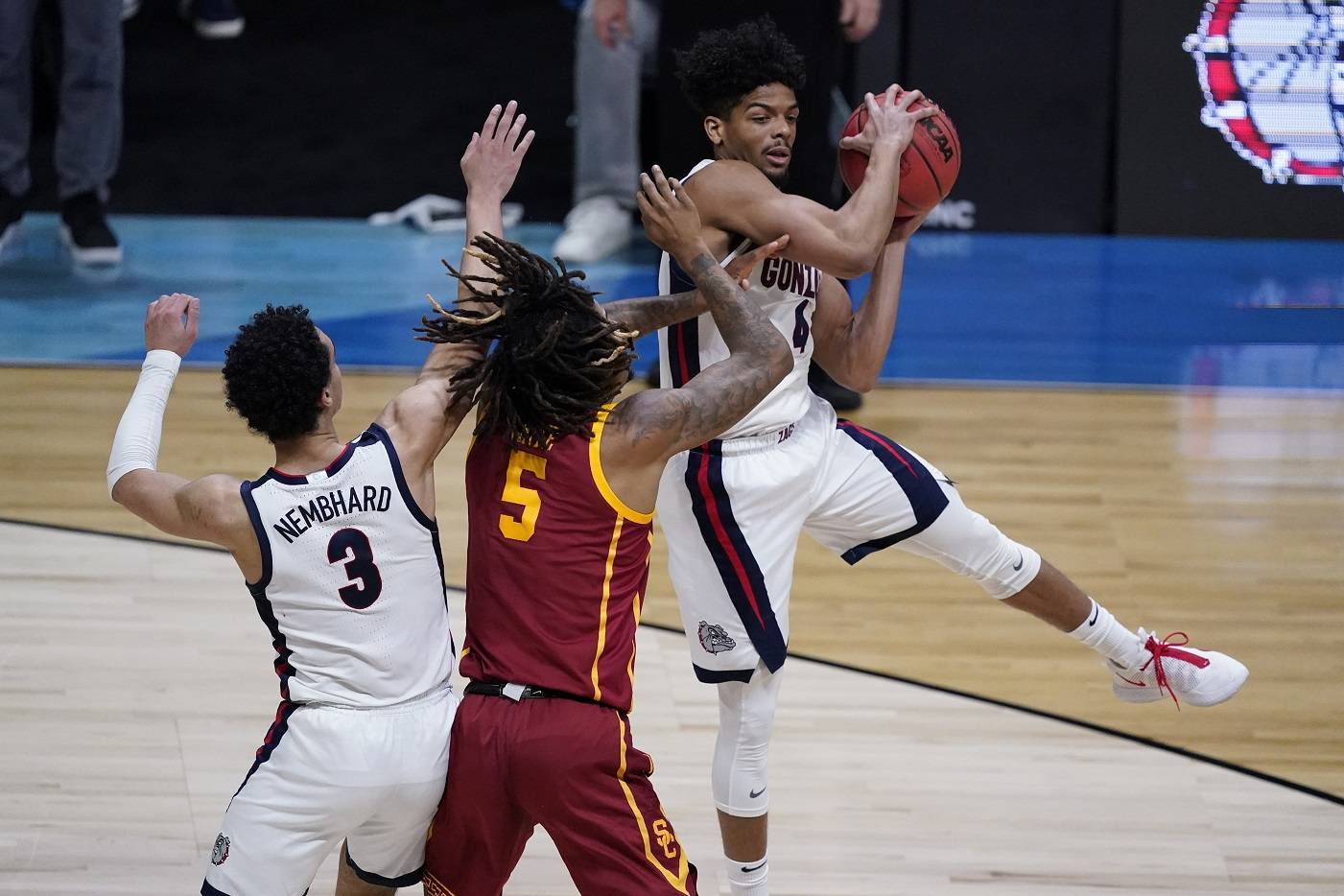 Gonzaga guard Aaron Cook, grabs a rebound over Southern California guard Isaiah White (5) during the first half of an Elite 8 game in the NCAA mens college basketball tournament at Lucas Oil Stadium, Tuesday, March 30, 2021, in Indianapolis. (AP Photo/Darron Cummings)