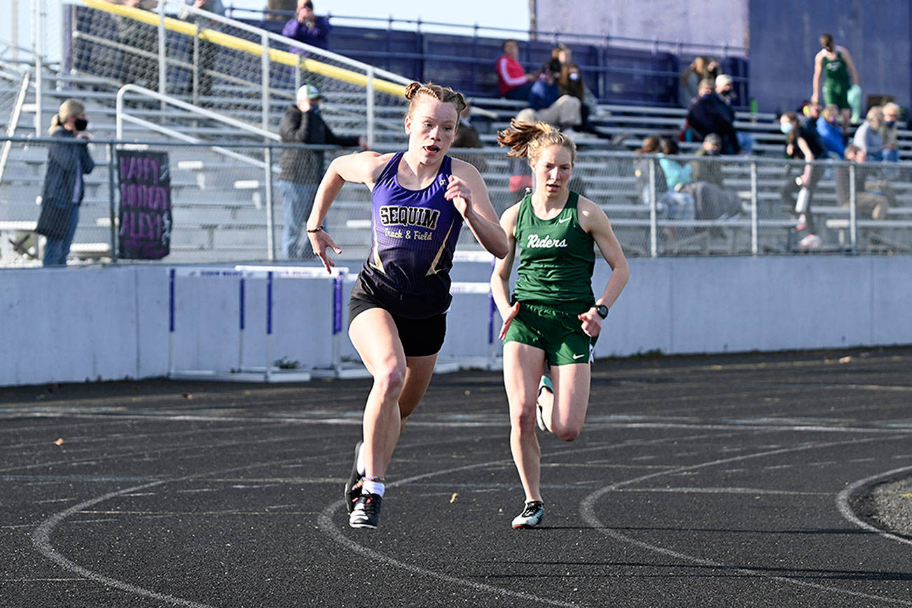 Sequim's Riley Pyeatt, left, and Port Angeles' Lauren Larson race during the 800-meter run at a track meet held in Sequim on Wednesday. Larson won the 800 and the 1,600 run while Pyeatt claimed the 100- and 400-meter races. (Michael Dashiell/Olympic Peninsula News Group)