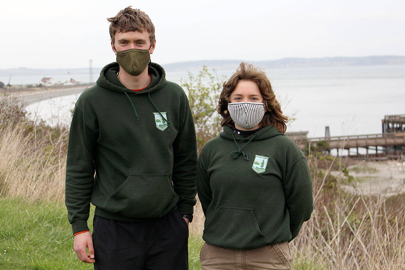 AmeriCorps service members Nathan Rees, left, and Anna Marchand will lead guided walks through Fort Worden State Park starting Saturday. (Zach Jablonski/Peninsula Daily News)