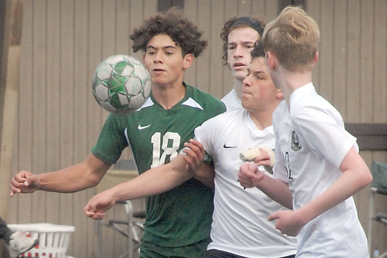 Keith Thorpe/Peninsula Daily News
Port Angeles' Dayton Williams, left, chases a loose ball against Klahowya players, from left, Zachary Sullivan, Oscar Peterson and Colin Swenland on Saturday at Wally Sigmar Field in Port Angeles.