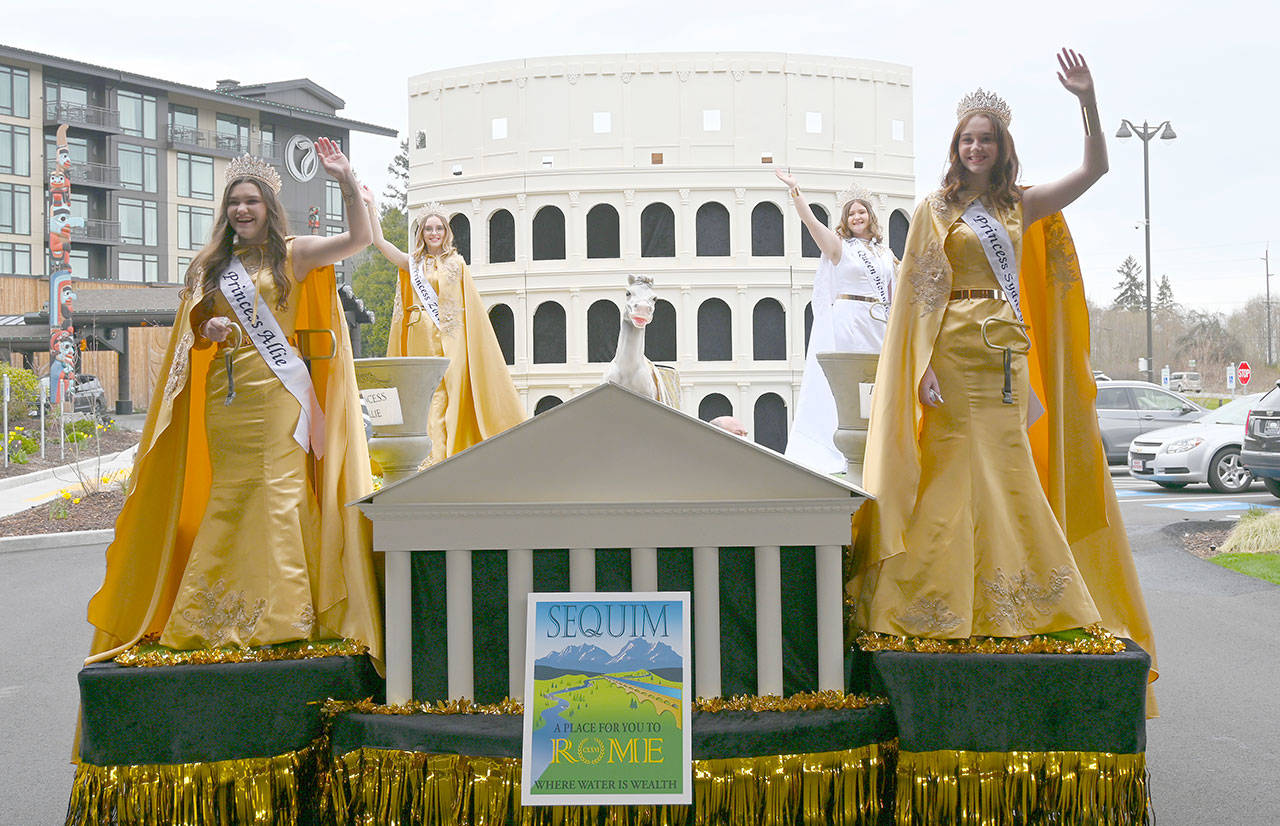 Sequim Irrigation Festival’s 2021 royalty get their first look at the float set for this year’s schedule of parades at a reveal event on Saturday at 7 Cedars Hotel and Casino. Pictured, from left, are princesses Allie Gale and Zoee Kuperus, queen Hannah Hampton and princess Sydney VanProyen. The float bears the theme “A Place For You to Rome,” complete with Roman architecture and designs overseen by longtime float builder/coordinator Guy Horton. The reveal preceded the annual Kick Off Dinner and Auction, a major annual fundraiser for the festival. With some COVID-related restrictions still in place, most of the events have been moved to May 8. (Michael Dashiell/Olympic Peninsula News Group)
