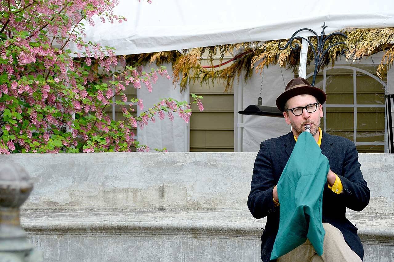 Clarinetist Jonathan Doyle, complete with an aerosol-masking instrument cover, jazzed up the Haller Fountain in downtown Port Townsend in the first Buskers on the Block gig. The series will showcase local musicians Thursdays and Saturdays through May. (Diane Urbani de la Paz/Peninsula Daily News)