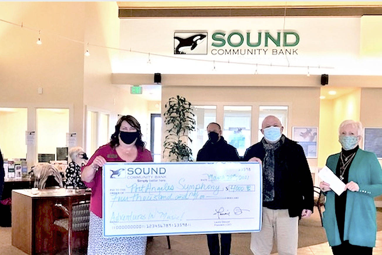 Accepting a donation from Sound Community Bank are Port Angeles Symphony conductor Jonathan Pasternack, center, Adventures in Music producer Al Harris and symphony board member Kathleen Balducci, at right; Sound Community Bank's Laurie Szczepczynski is at left with Sequim manager Shelli Robb-Kahler. (Photo courtesy Sound Community Bank)