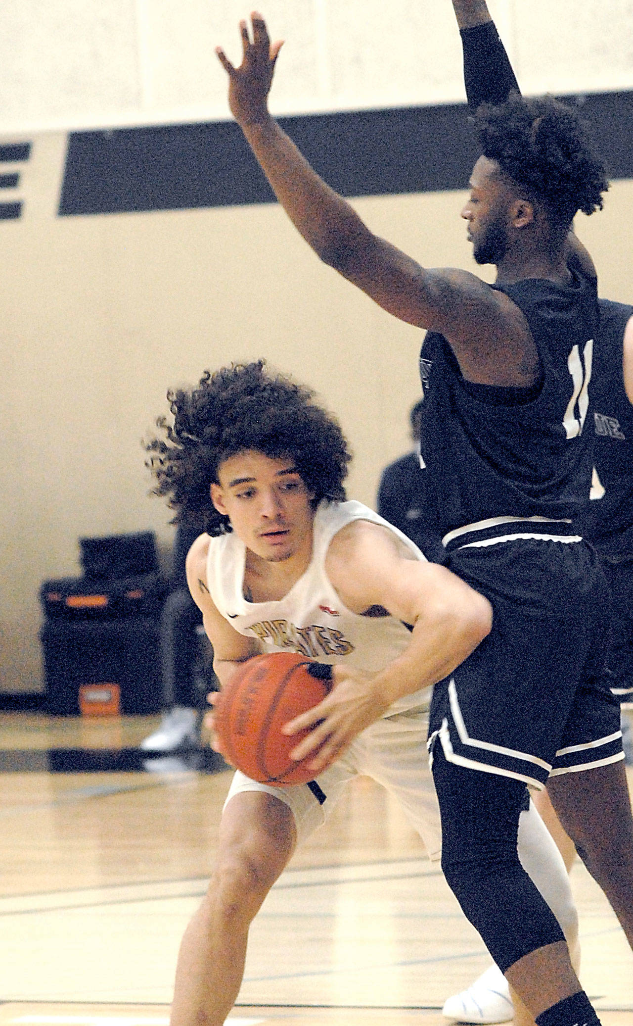 Peninsula’s KeAndre Hunter-Holiday, left, leans past Bellevue’s O’Landa Baker on Saturday afternoon in Port Angeles. (Keith Thorpe/Peninsula Daily News)