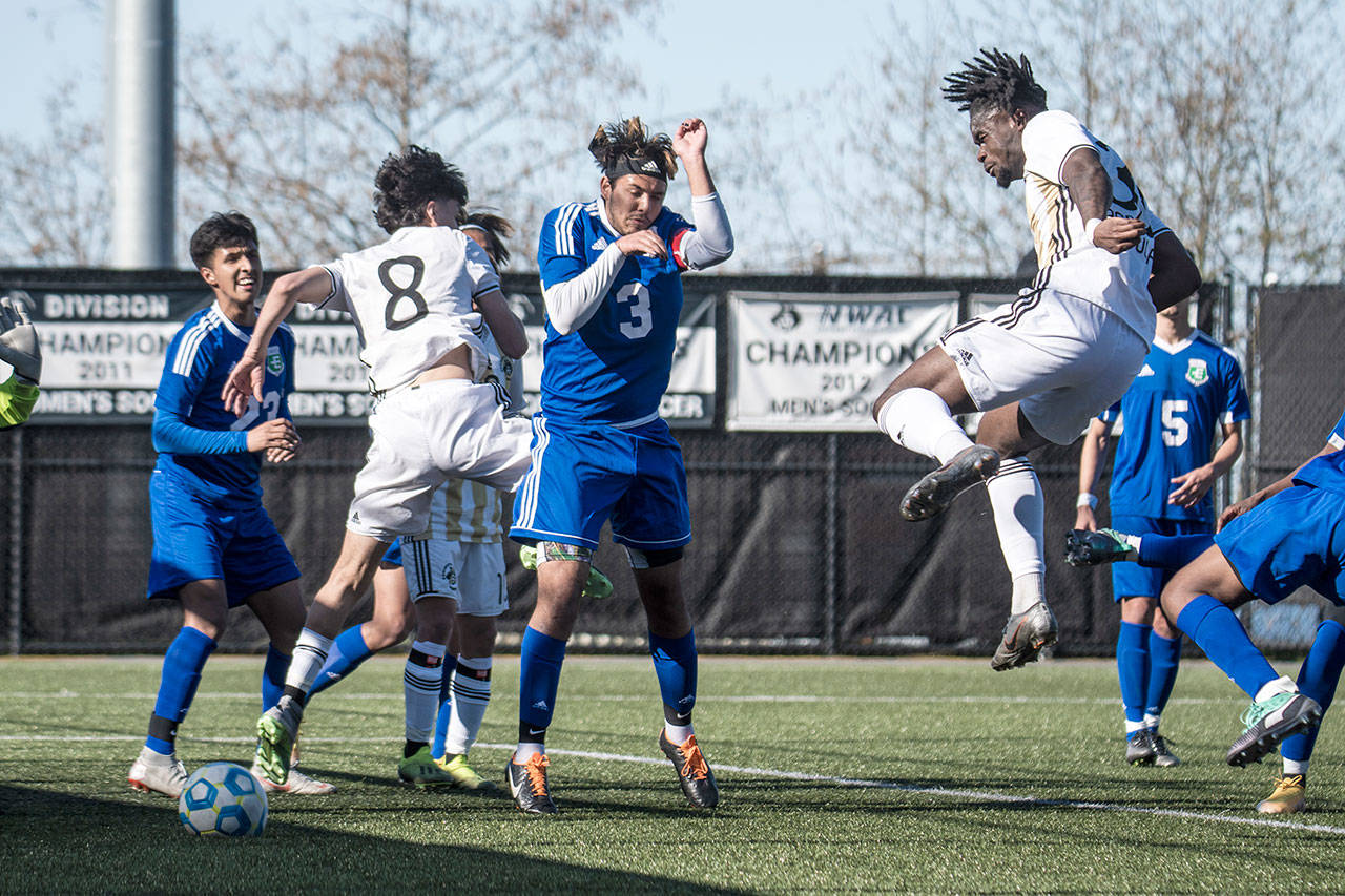 Peninsula defender Dylan Pauw, right, heads the ball toward the goal in front of a tangle of Edmonds players and teammate Juan Hernandez during the Pirates 5-1 season-opening win Monday at Wally Sigmar Field. (Jesse Major/for Peninsula Daily News)
