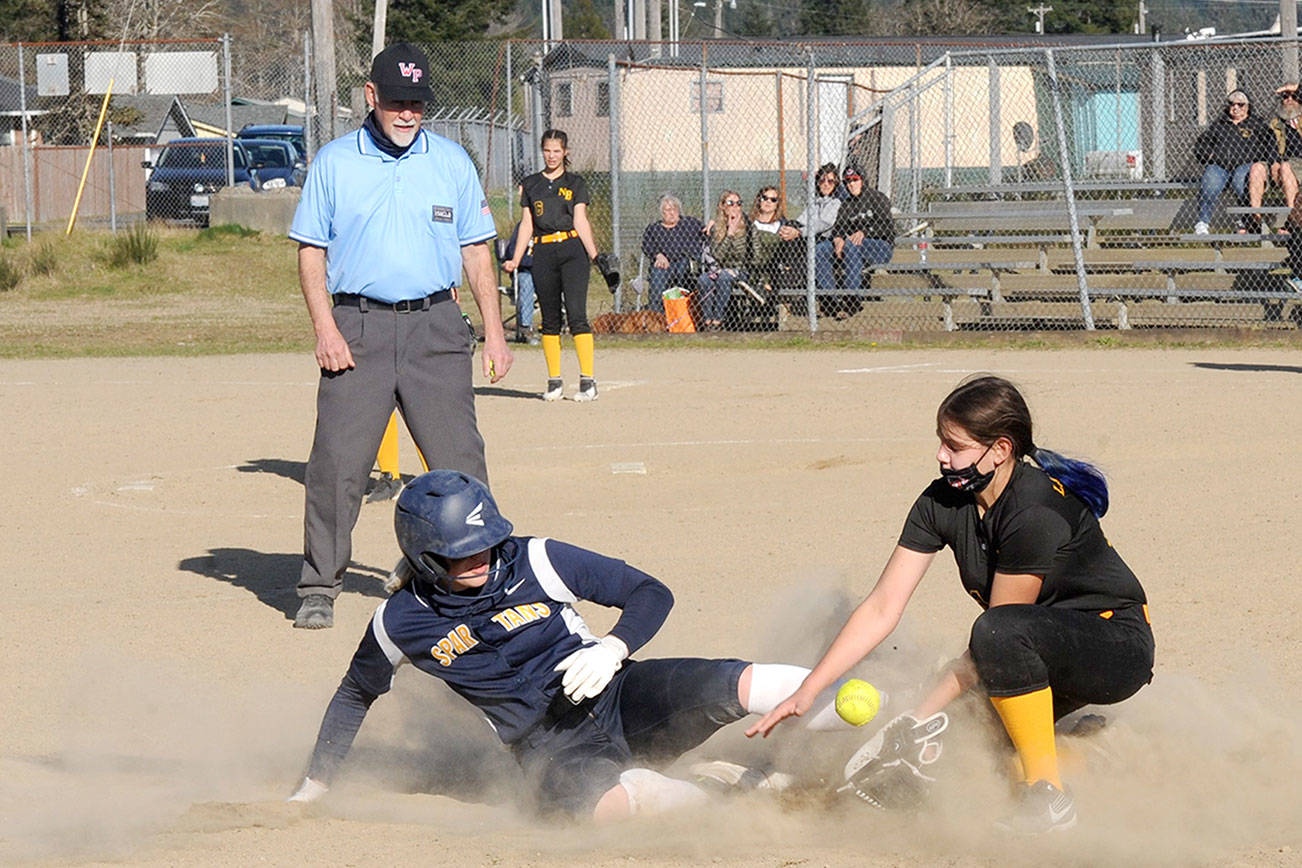 Forks’ Kyra Neel, left, slides safely into third base under the watchful eye of umpire Randy Rooney Tuesday afternoon in the second game of a doubleheader against North Beach at Tillicum Park in Forks. (Lonnie Archibald/for Peninsula Daily News)