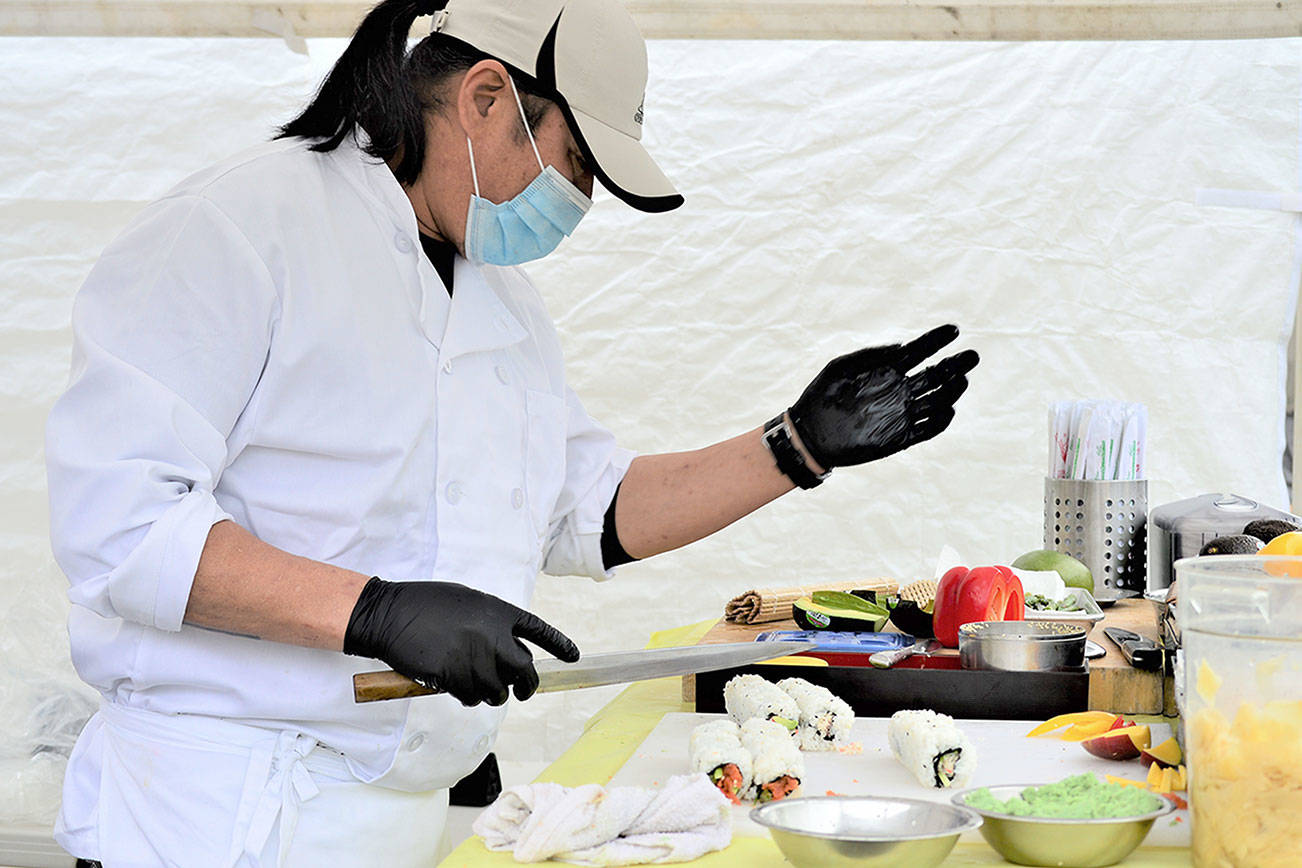 Chef Wyatt Park, pictured in this file photo, shapes his sushi creations at the Jefferson County Farmers Market in Uptown Port Townsend on Saturdays. Along with dozens of other food and artisan vendors, Park mans his stand from 9 a.m. to 2 p.m. at Tyler and Lawrence streets. For those who prefer to shop for fresh produce by computer or mobile device, JCFmarkets.org keeps its online market open for orders till 1 p.m. today. (Diane Urbani de la Paz/Peninsula Daily News)