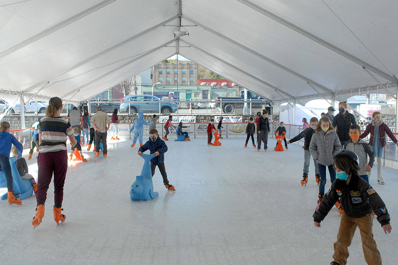 Keith Thorpe/Peninsula Daily News
Skaters make their way around the ice at the Port Angeles Winter Ice Village.