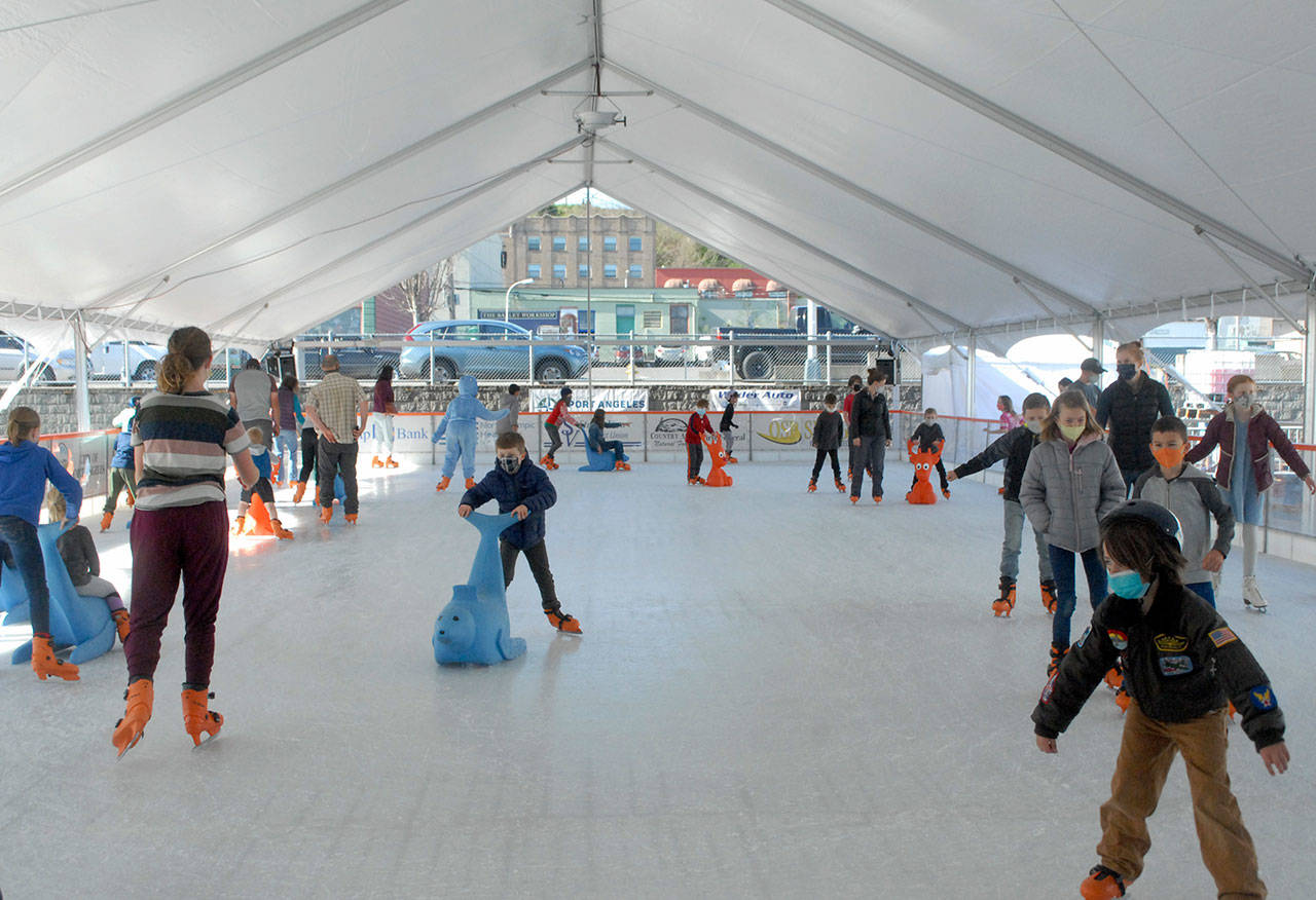 Skaters make their way around the ice at the Port Angeles Winter Ice Village. (Keith Thorpe/Peninsula Daily News)