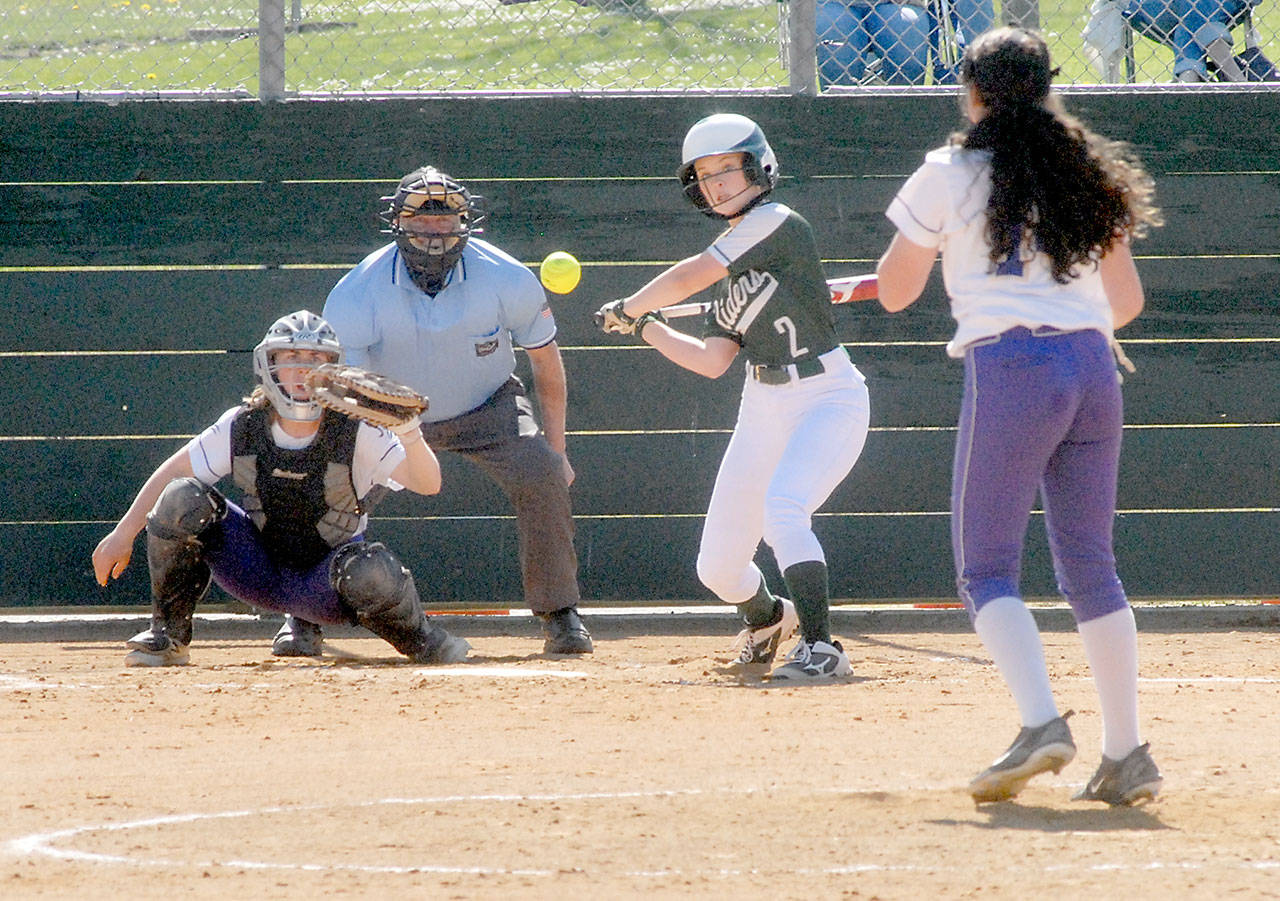 Port Angeles’ Peyton Rudd bats against Sequim pitcher Laina Vig as catcher Christy Grubb waits for the ball in the second inning on Saturday in Port Angeles. Rudd homered on the pitch. (Keith Thorpe/Peninsula Daily News)