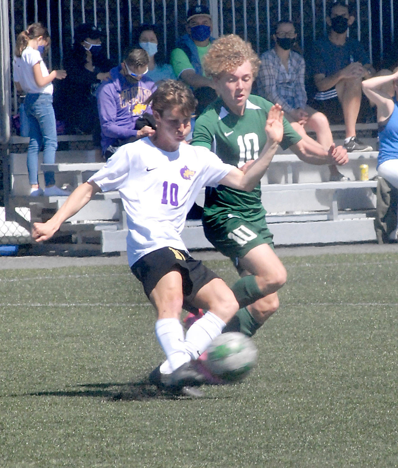 Keith Thorpe/Peninsula Daily News Sequims Eli Gish, left, and Port Angeles Damon Gundersen compete for control at midfield on Saturday at Peninsula College.