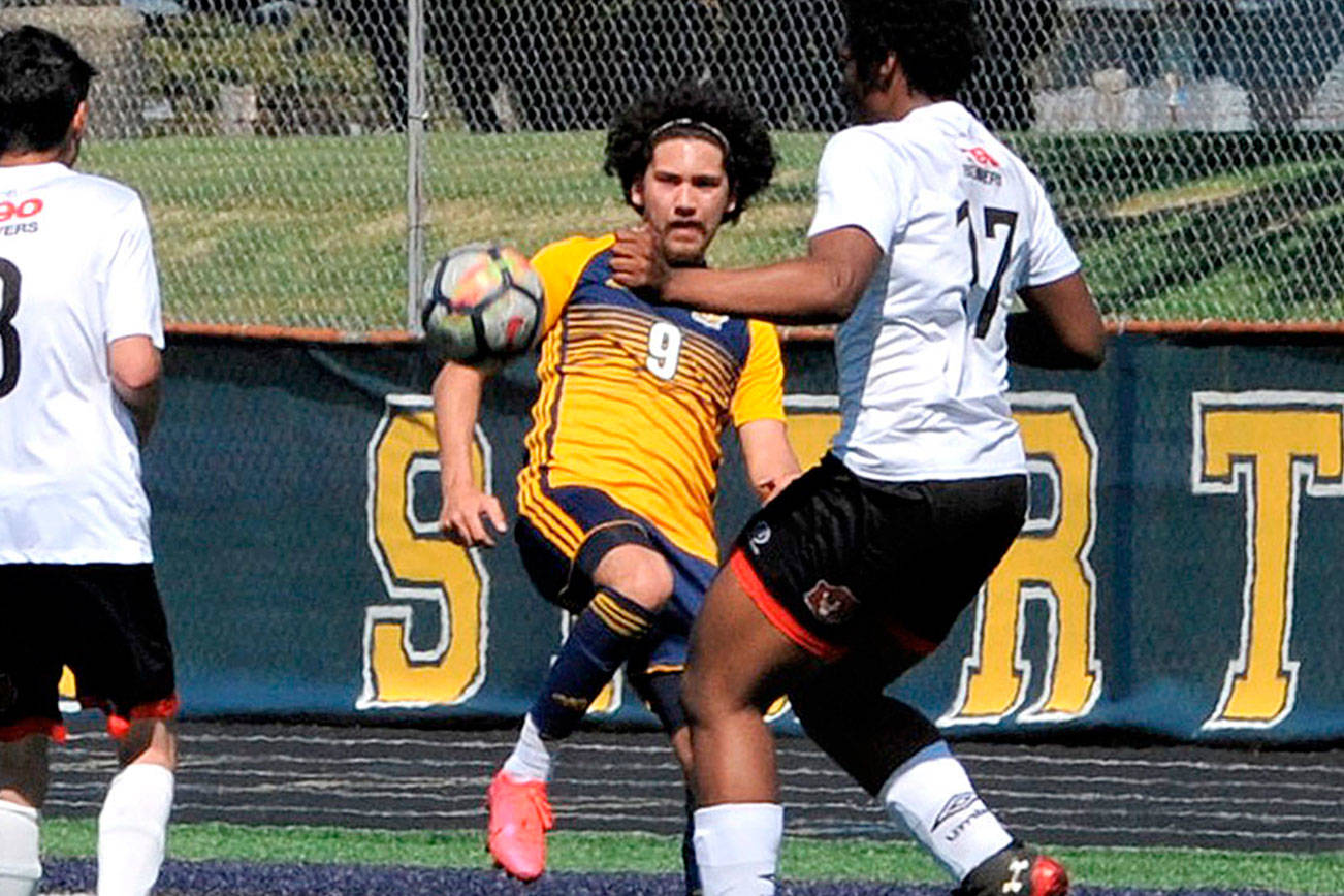 Forks' Tony Flores-Hernandez (9) battles for a loose ball against Elma in Forks on Saturday. (Lonnie Archibald/for Peninsula Daily News)