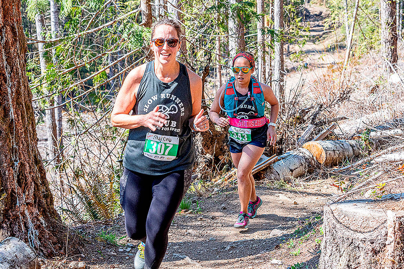 Debbie Proctor of Vancouver (307) and Sherry Xiong of Port Angeles (343) run in the half-marathon of the Olympic Adventure Trail run Saturday. (Photo by Matt Sagen, Cascadia Films)