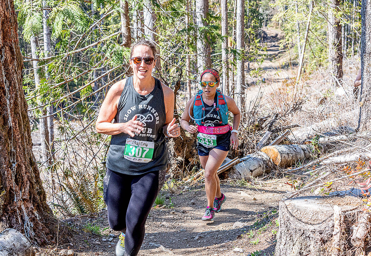 Debbie Proctor of Vancouver (307) and Sherry Xiong of Port Angeles (343) run in the half-marathon of the Olympic Adventure Trail run Saturday. (Photo by Matt Sagen, Cascadia Films)