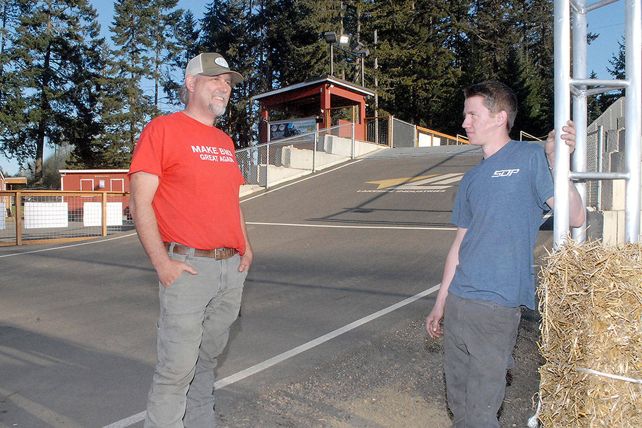 Port Angeles BMX track president and operator Sean Coleman, left, talks with track design assistant Colby Groves, 17, at the track. (Keith Thorpe/Peninsula Daily News)