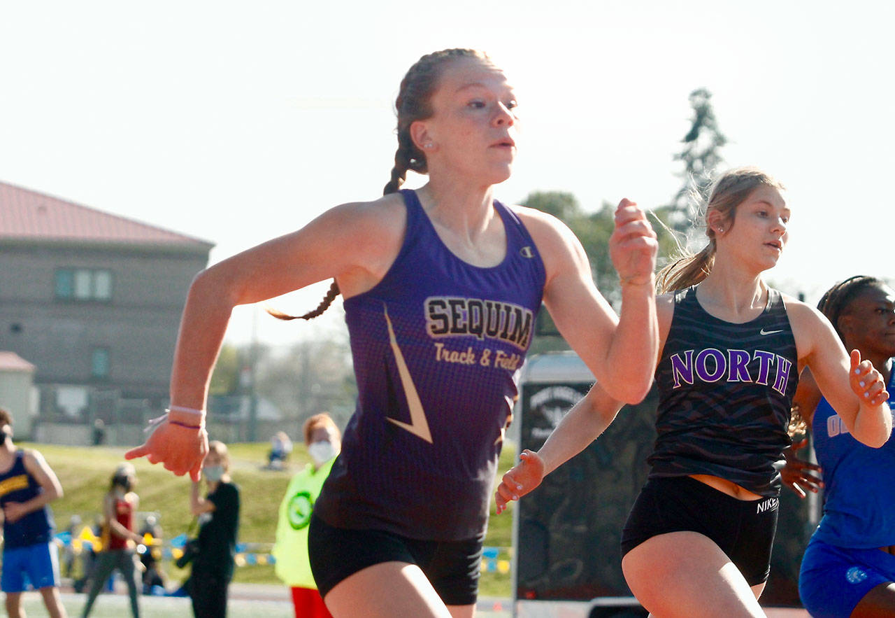 Sequim’s Riley Pyeatt runs neck-and-neck with Lillian Pruden of North Kitsap in the 100-meter race. She finished second in the 100 but set a school record time in the 400 at the Class 1A/2A/3A Olympic League Championships at Bremerton High School. (Mark Krulish/Kitsap News Group)