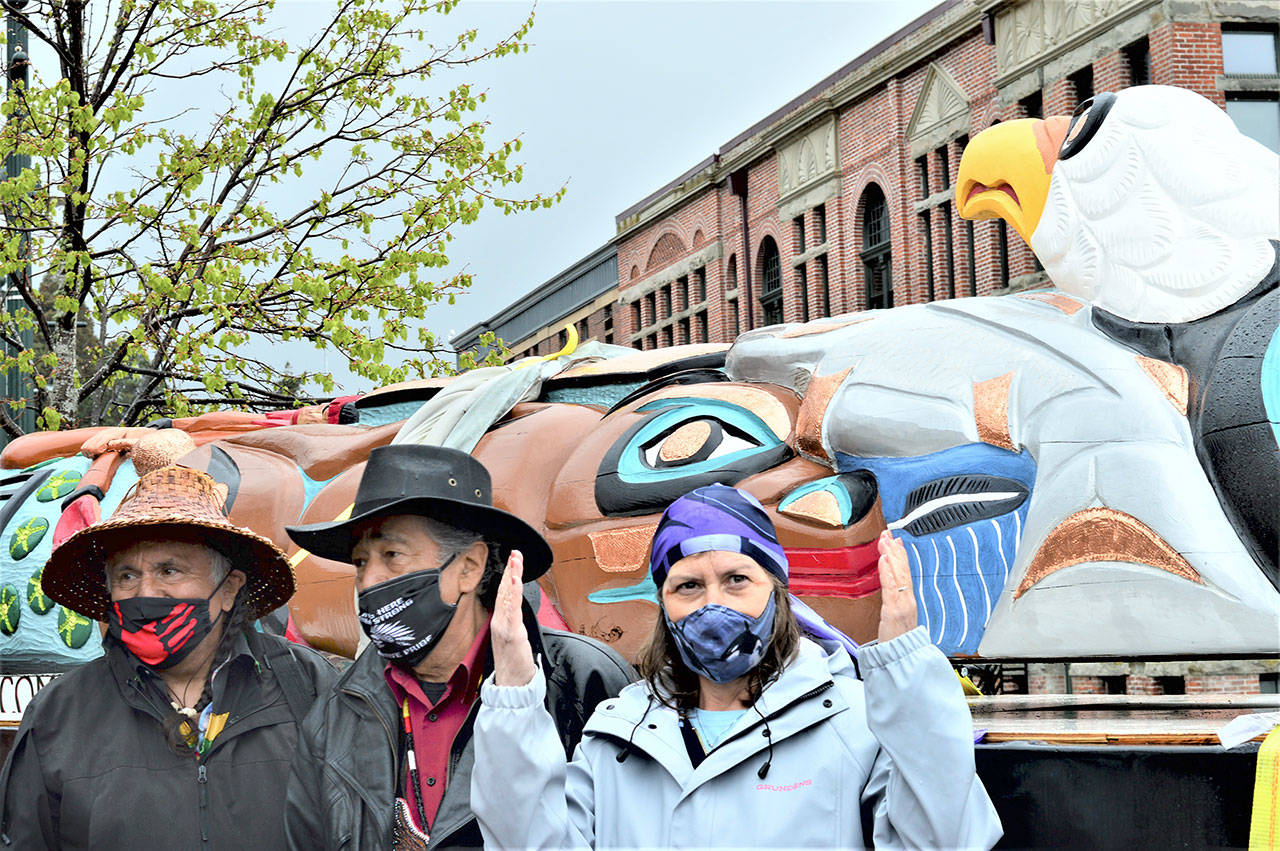 Carvers Se Sealth, also known as Jewell James, left, his brother Sit ki kadem, also called Doug James, and Dougs wife, Siamelwit James, accompanied the Lummi House of Tears totem pole to downtown Port Townsend on Saturday. (Diane Urbani de la Paz/Peninsula Daily News)