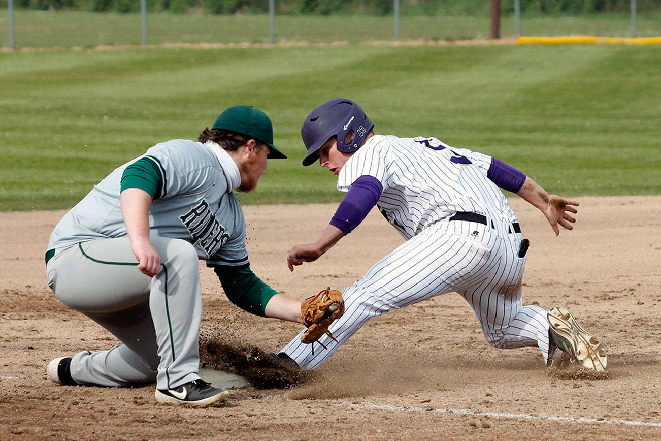 Port Angeles' Seth Woods tries to put the tag on North Kitsap's Colton Bower Friday in Poulsbo. The Roughriders won the game 9-4 after scoring eight runs in the seventh inning. (Mark Krulish/Olympic Peninsula News Group)