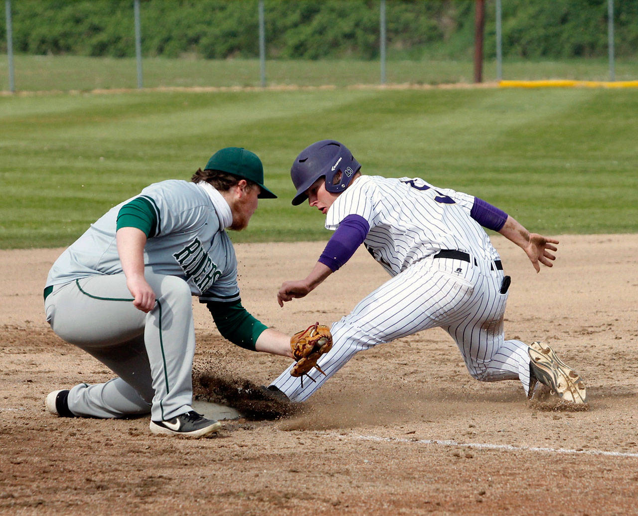 Port Angeles’ Seth Woods tries to put the tag on North Kitsap’s Colton Bower Friday in Poulsbo. The Roughriders won the game 9-4 after scoring eight runs in the seventh inning. (Mark Krulish/Olympic Peninsula News Group)